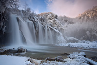 Winter dawn under the waterfall 
