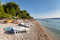 People relaxing and swimming on the famous beach Punta Rata in place Brela, Dalmatia, Croatia