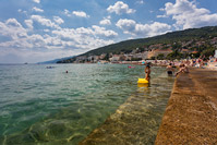 People swimming in front of popular resort Opatija, Kvarner, Croatia