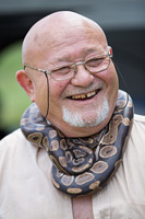 Man with his boa snake pet around his neck, Dalmatia, Croatia