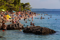 People swimming on the famous beach Punta Rata in place Brela, Dalmatia, Croatia