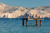 People enjoying on the famous beach in town Baska, island Krk, Kvarner, Croatia