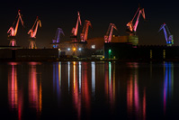 Lightning cranes of Uljanik "shipyard" at night in town Pula/Istria, Croatia